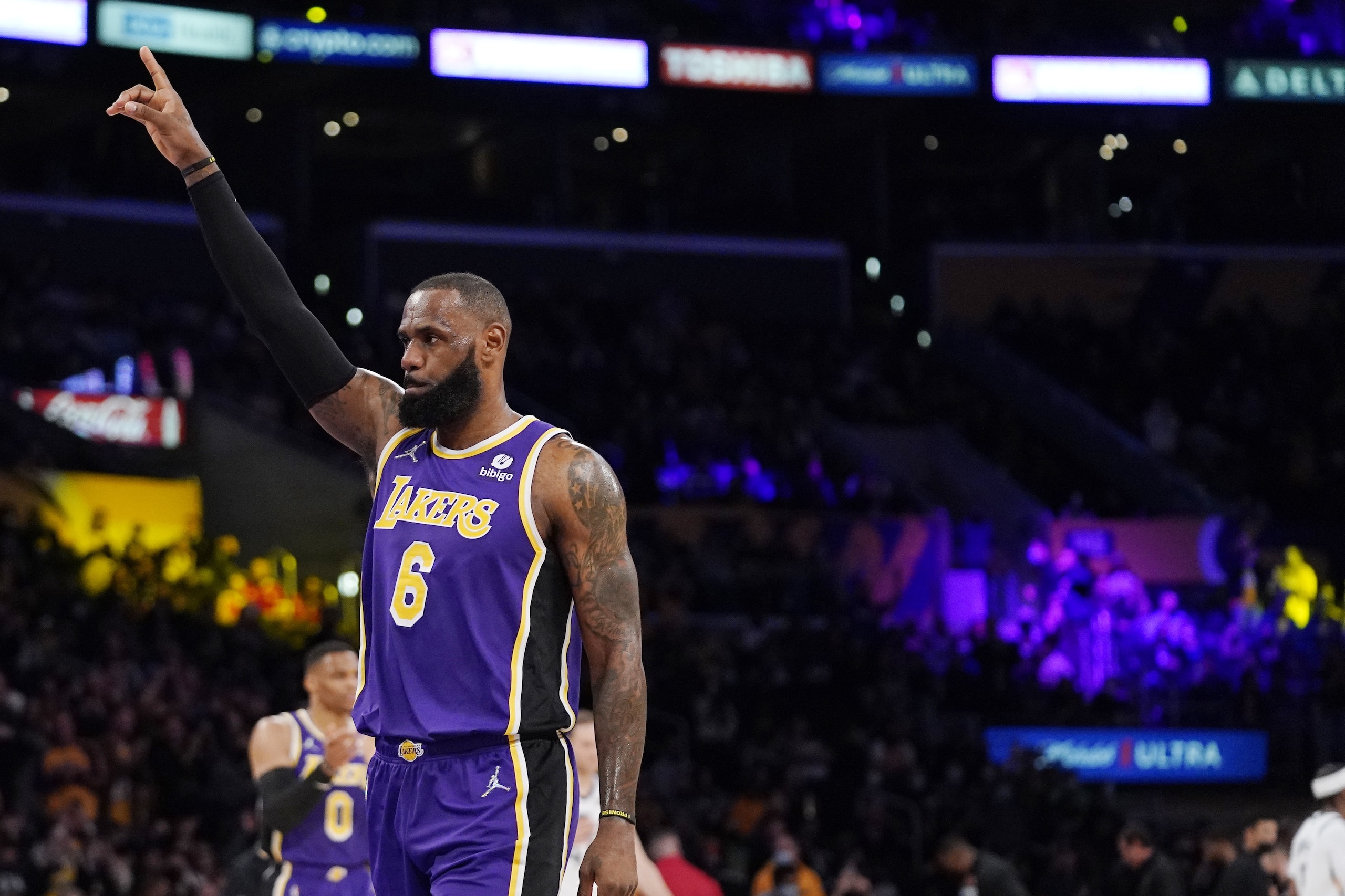 Los Angeles Lakers forward LeBron James acknowledges the crowd during the first half of an NBA basketball game against the Utah Jazz Wednesday, Feb. 16, 2022, in Los Angeles after the Lakers showed a tape to commemorate James' passing Kareem Abdul-Jabbar for most combined points in regular season and playoffs. James achieved the feat on Feb. 12th. (AP Photo/Mark J. Terrill)