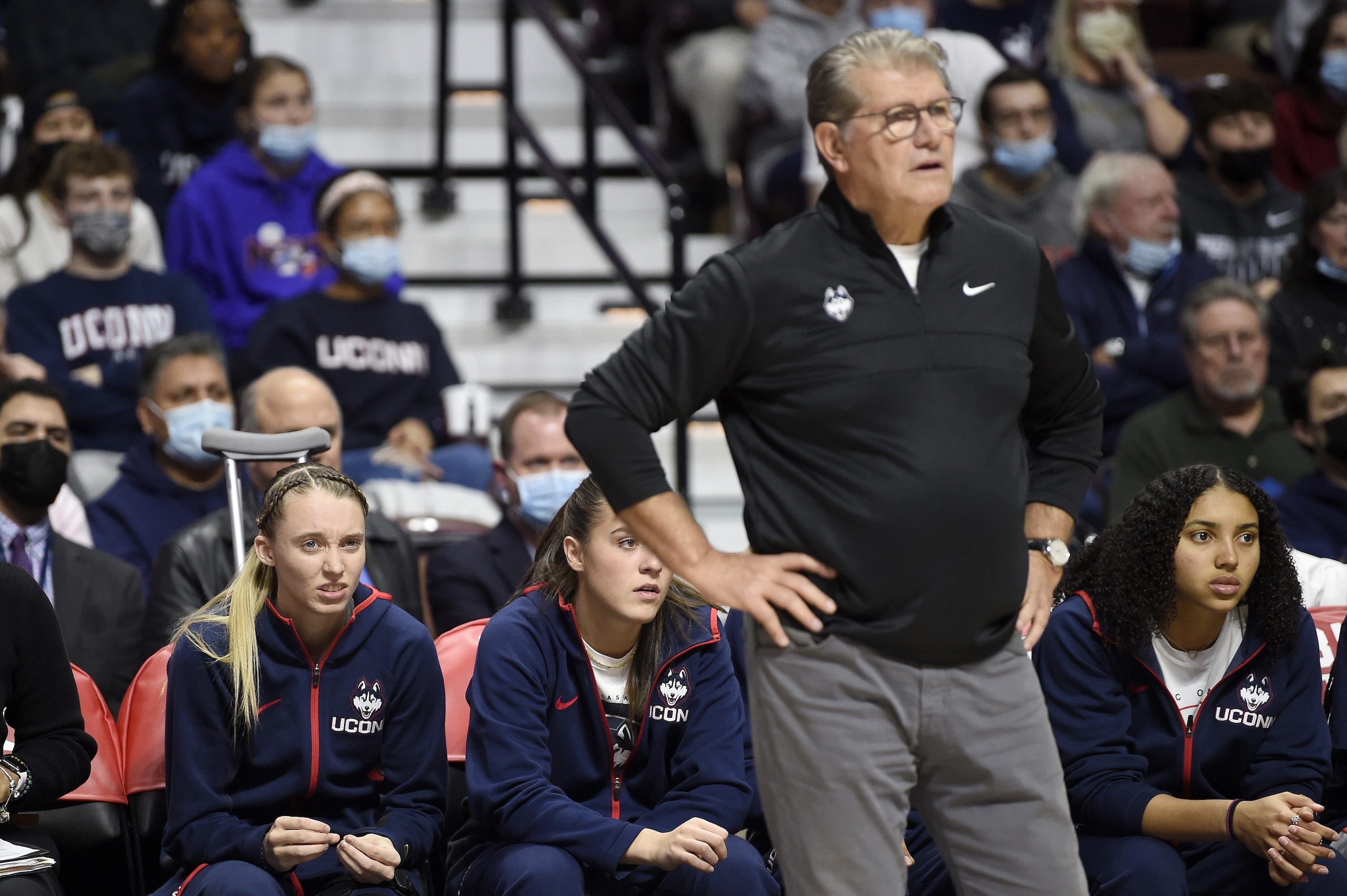 UNCASVILLE, CONNECTICUT - DECEMBER 19: Paige Bueckers #5 of the Connecticut Huskies watchethe game against the Louisville Cardinals in the Basketball Hall of Fame Women's Showcase at Mohegan Sun Arena on December 19, 2021 in Uncasville, Connecticut. (Photo by G Fiume/Getty Images)