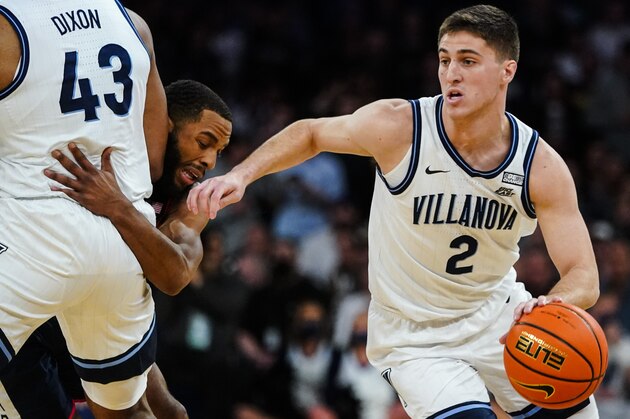 Villanova's Collin Gillespie (2) uses a screen by Eric Dixon (43) as Connecticut's R.J. Cole defends during the first half of an NCAA college basketball game in the semifinals of the Big East men's tournament Friday, March 11, 2022, in New York. (AP Photo/Frank Franklin II)
