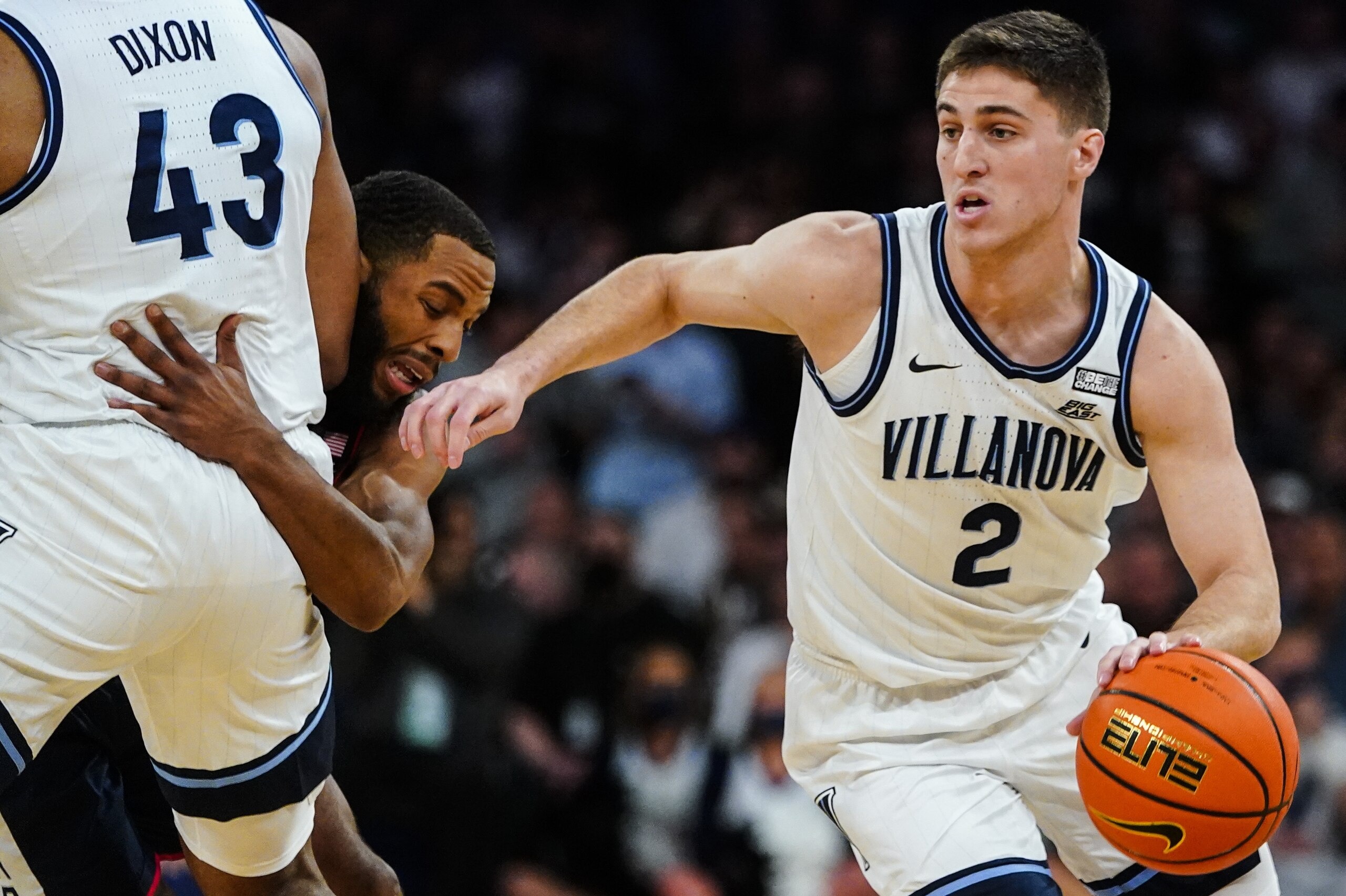 Villanova's Collin Gillespie (2) uses a screen by Eric Dixon (43) as Connecticut's R.J. Cole defends during the first half of an NCAA college basketball game in the semifinals of the Big East men's tournament Friday, March 11, 2022, in New York. (AP Photo/Frank Franklin II)