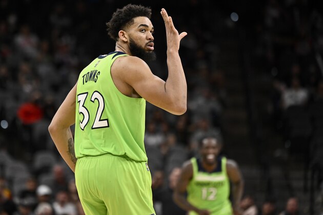 Minnesota Timberwolves' Karl-Anthony Towns celebrates a 3-point basket late in the second half of an NBA basketball game against the San Antonio Spurs on Monday, March 14, 2022, in San Antonio. (AP Photo/Darren Abate)