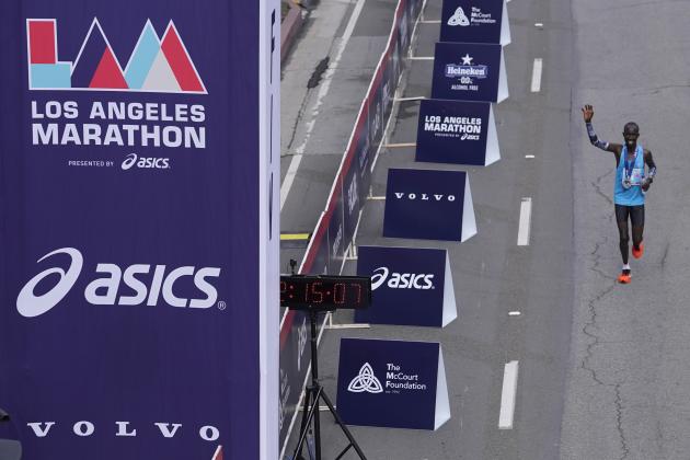 Elite runner John Korir, of Kenya, runs around the finish line to greet fans after winning the Los Angeles Marathon in Los Angeles, Sunday, Nov. 7, 2021. (AP Photo/Damian Dovarganes)