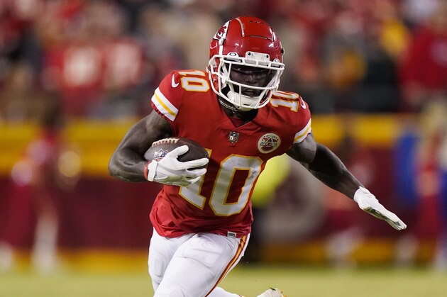 Kansas City Chiefs wide receiver Tyreek Hill (10) runs up field during the first half of an NFL divisional round playoff football game against the Buffalo Bills, Sunday, Jan. 23, 2022, in Kansas City, Mo. (AP Photo/Charlie Riedel)