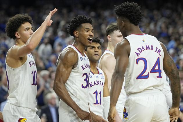 Kansas' Ochai Agbaji (30) celebrates with Jalen Wilson (10), Remy Martin (11) and K.J. Adams (24) after their win against Villanova in a college basketball game in the semifinal round of the Men's Final Four NCAA tournament, Saturday, April 2, 2022, in New Orleans. (AP Photo/David J. Phillip)