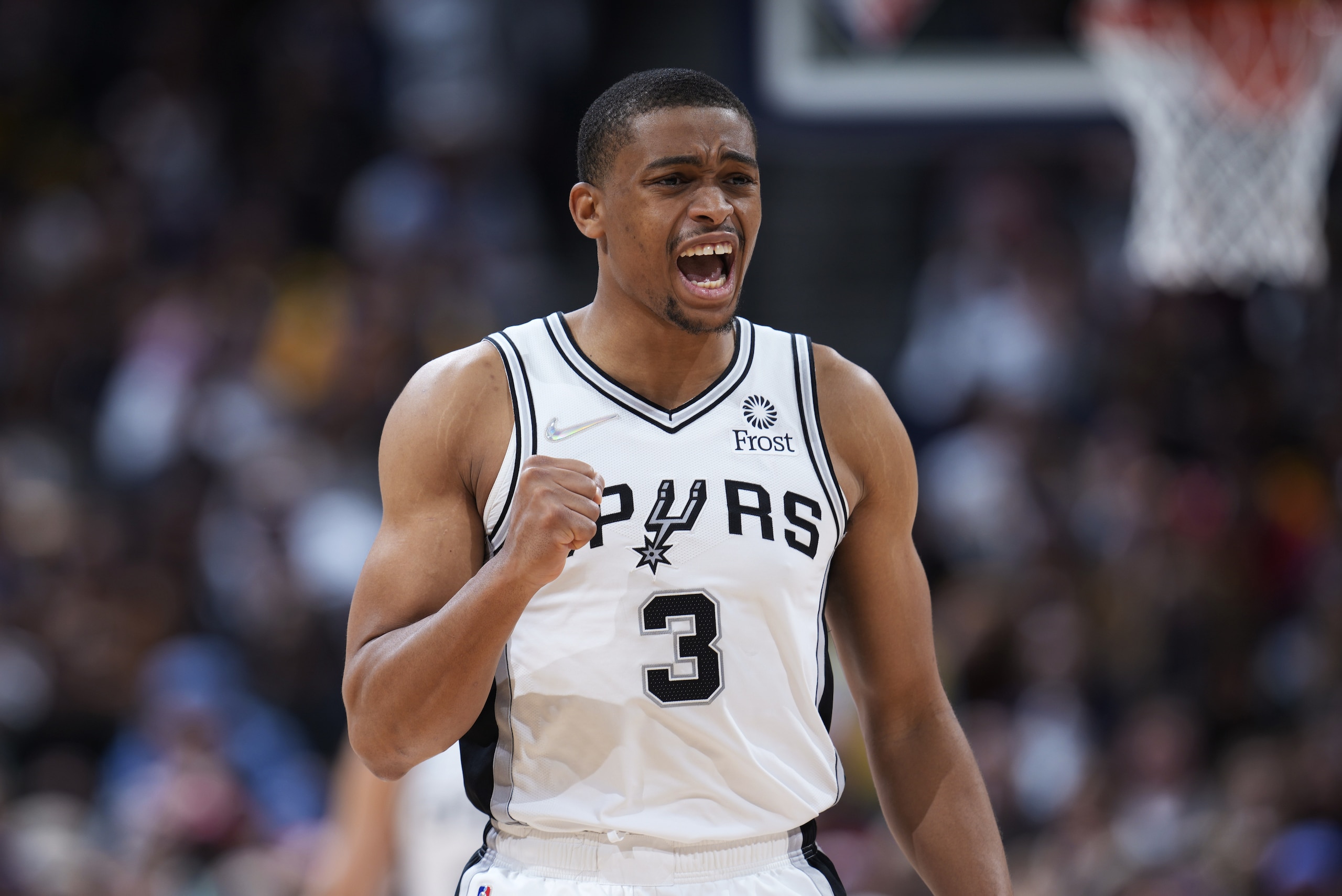 San Antonio Spurs forward Keldon Johnson reacts after center Jakob Poeltl hit a basket and was fouled during the second half of the team's NBA basketball game against the Denver Nuggets on Tuesday, April 5, 2022, in Denver. (AP Photo/David Zalubowski)