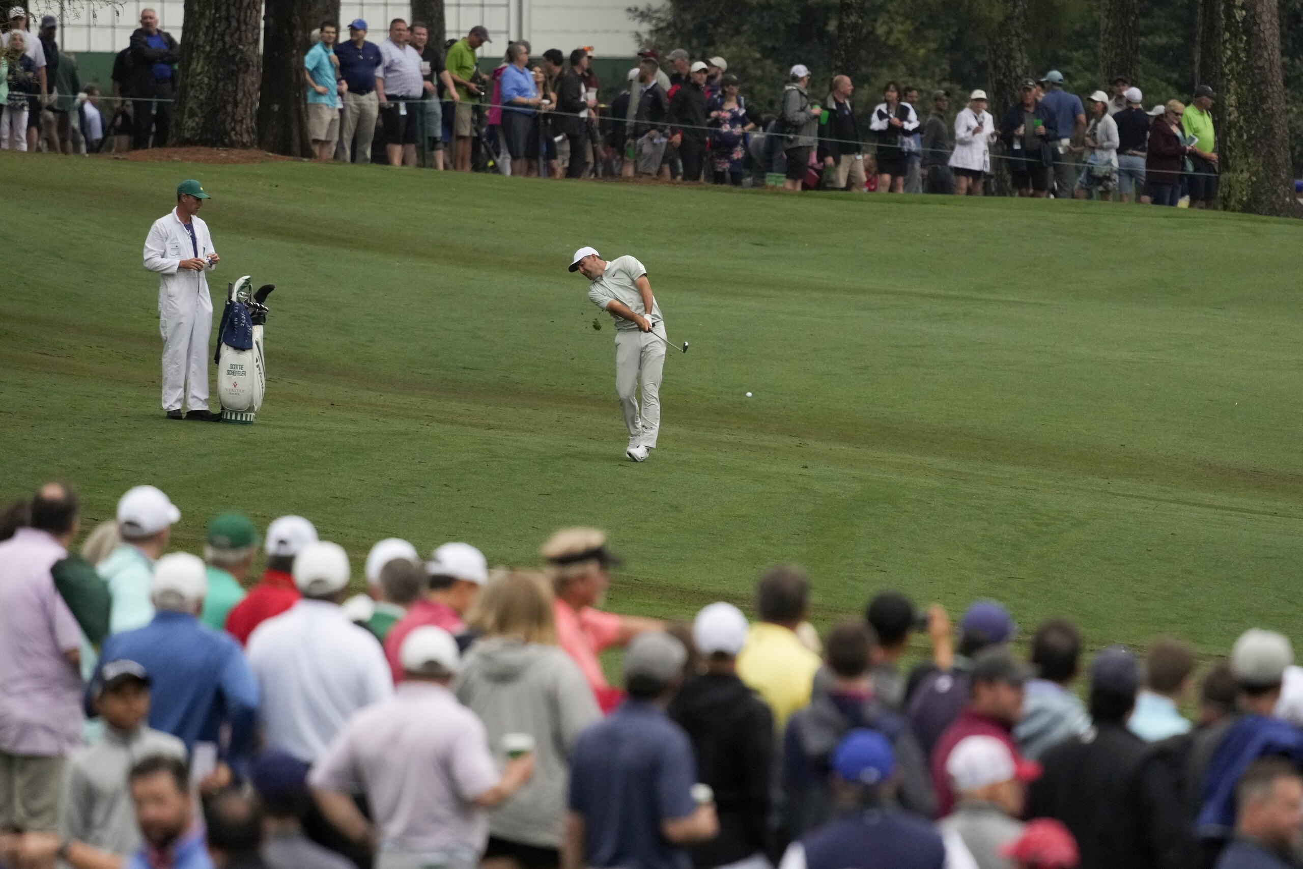 Scottie Scheffler hits on the 13th fairway during a practice round for the Masters golf tournament on Wednesday, April 6, 2022, in Augusta, Ga. (AP Photo/Charlie Riedel)