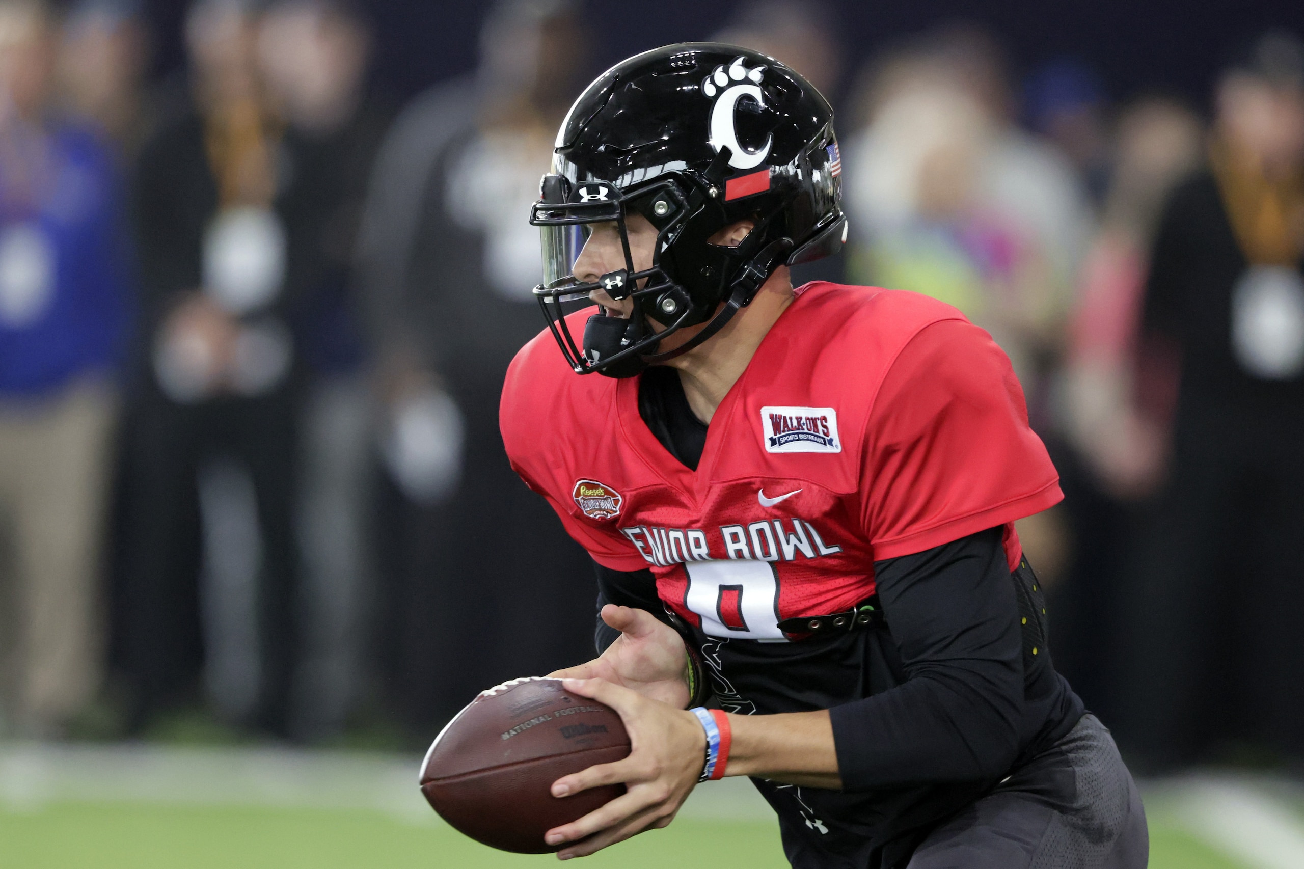 National Team quarterback Desmond Ridder of Cincinnati (9) runs through drills during practice for the Senior Bowl NCAA college football game Thursday, Feb. 3, 2022, in Mobile, Ala. (AP Photo/Butch Dill)