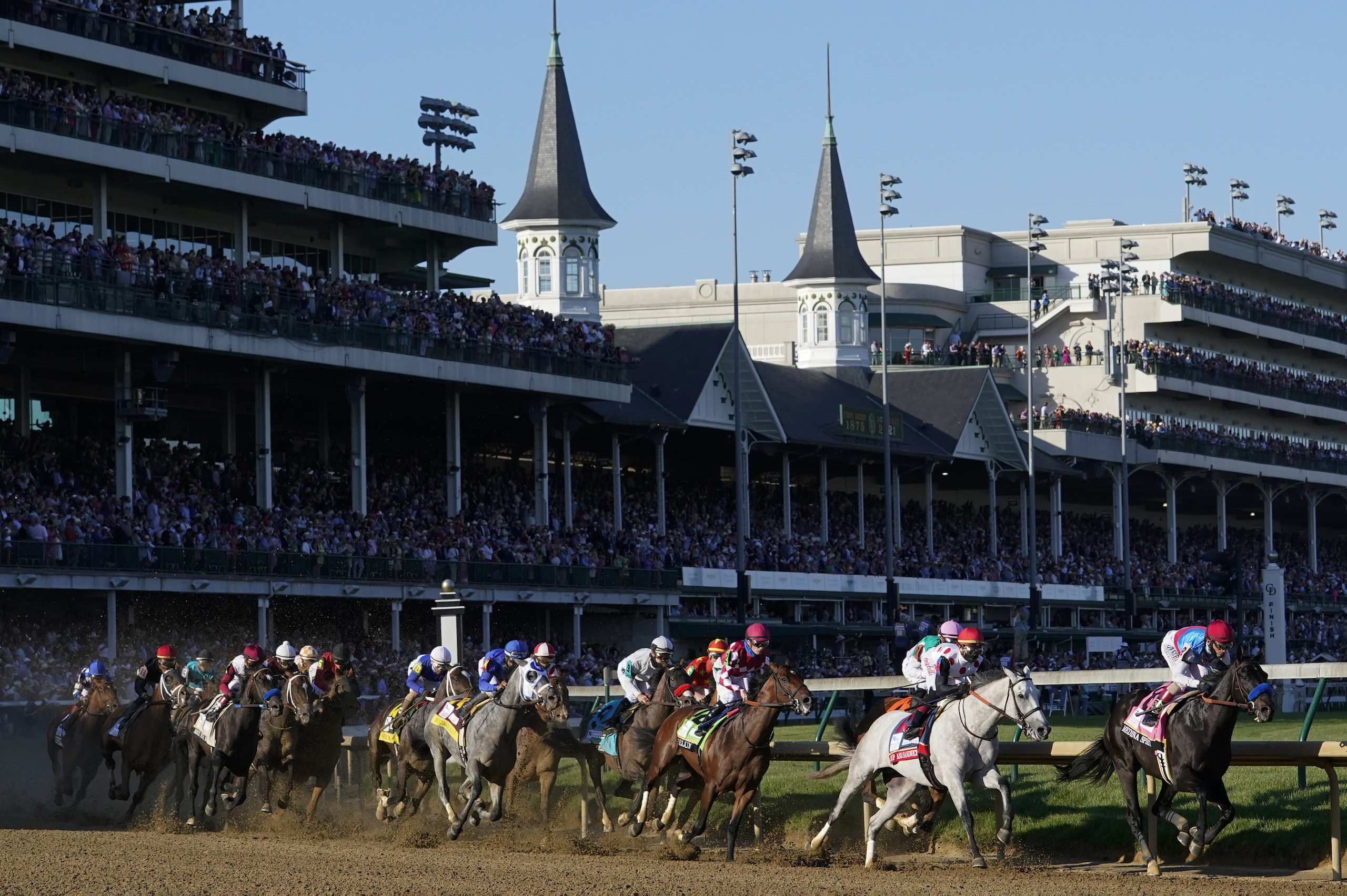 Medina Spirit, right, with John Velazquez aboard, leads the field around the first turn on the way to winning the 147th running of the Kentucky Derby at Churchill Downs, Saturday, May 1, 2021, in Louisville, Ky. (AP Photo/Michael Conroy)