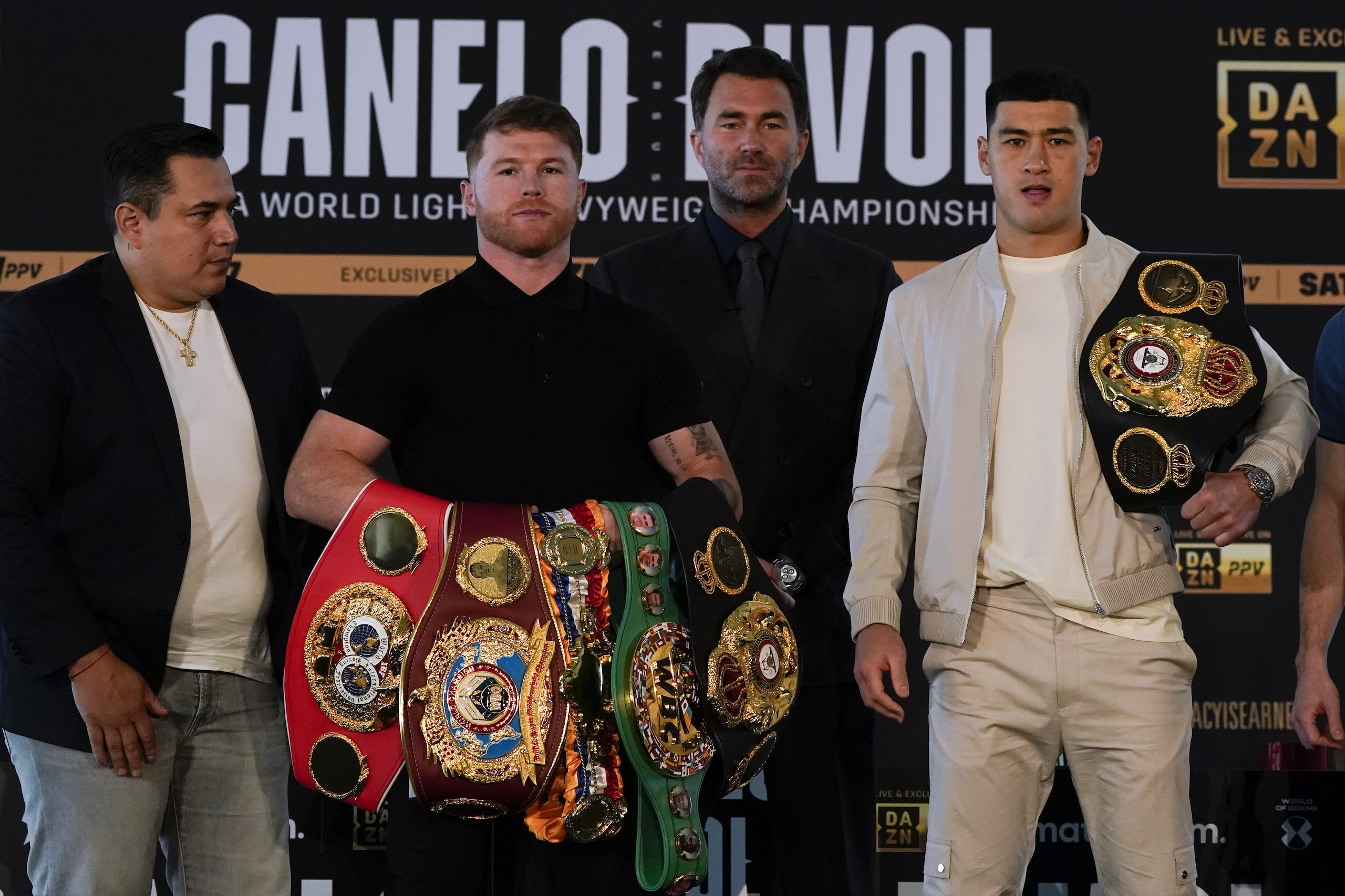 Canelo Alvarez, second from left, of Mexico, poses with Dmitry Bivol, right, of Russia, Wednesday, March 2, 2022, in San Diego as promoter Eddie Hearn, second from right, and Alvarez's trainer, Eddy Reynoso, left, look on. Alvarez is scheduled to fight Bivol in a boxing bout in Las Vegas on May 7. (AP Photo/Gregory Bull) Canelo Alvarez, second from left, of Mexico, poses with Dmitry Bivol, right, of Russia, Wednesday, March 2, 2022, in San Diego as promoter Eddie Hearn, second from right, and Alvarez's trainer, Eddy Reynoso, left, look on. Alvarez is scheduled to fight Bivol in a boxing bout in Las Vegas on May 7. (AP Photo/Gregory Bull)