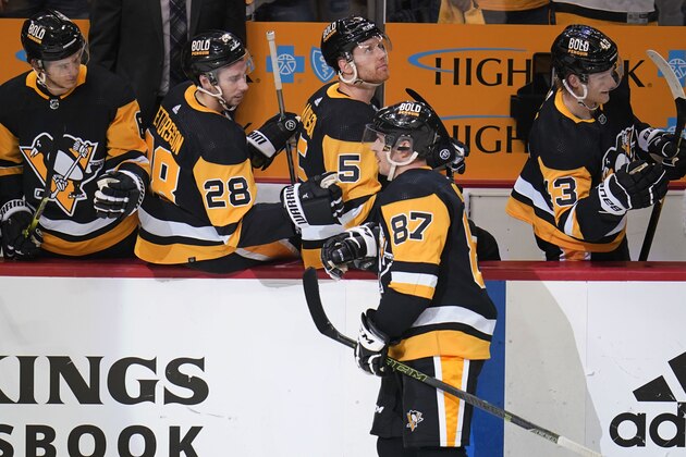 Pittsburgh Penguins' Sidney Crosby (87) returns to the bench after scoring during the first period in Game 4 of an NHL hockey Stanley Cup first-round playoff series against the New York Rangers in Pittsburgh, Monday, May 9, 2022. (AP Photo/Gene J. Puskar)