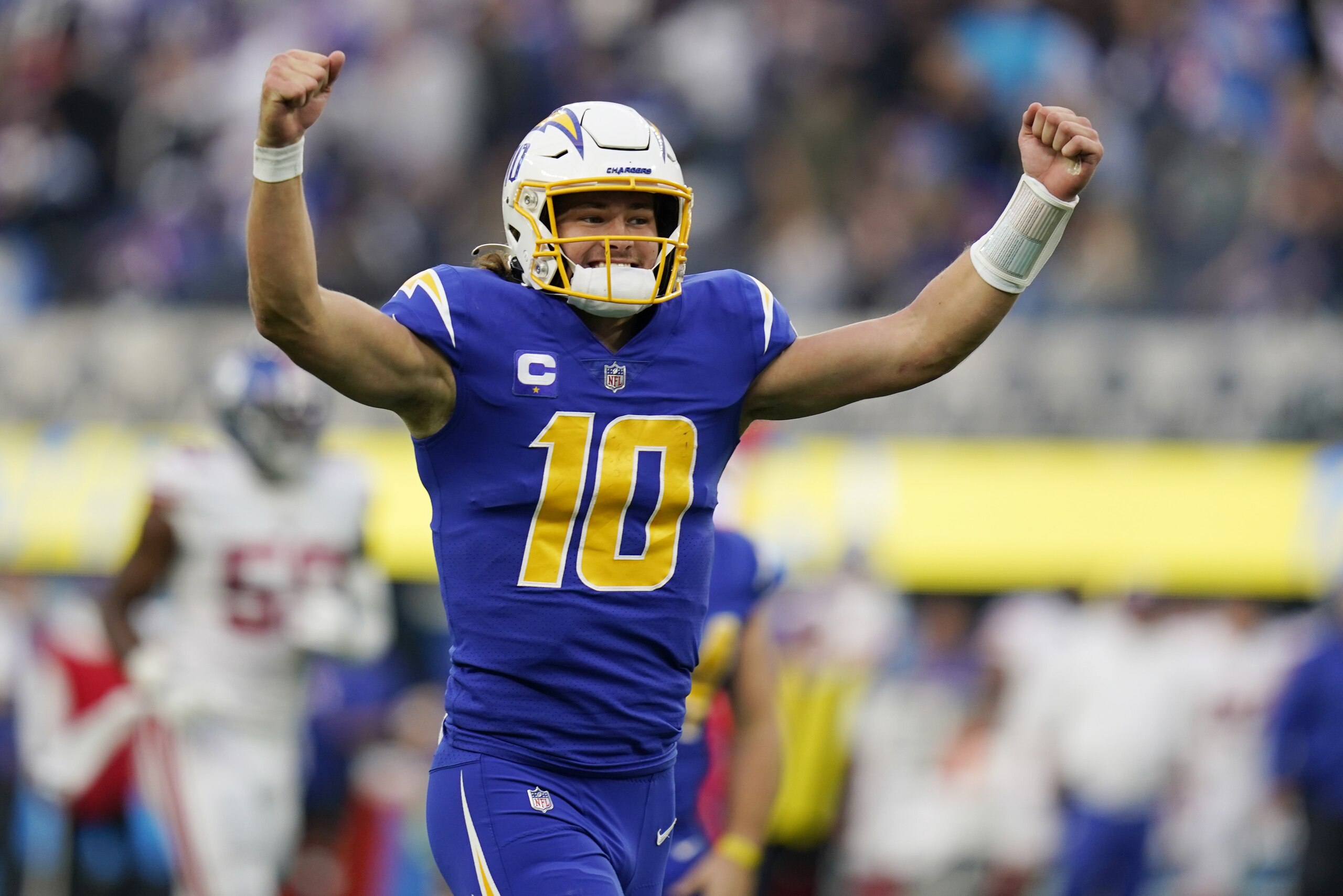 Los Angeles Chargers quarterback Justin Herbert celebrates after throwing a pass to wide receiver Jalen Guyton during the first half of an NFL football game Sunday, Dec. 12, 2021, in Inglewood, Calif. (AP Photo/Gregory Bull) Los Angeles Chargers quarterback Justin Herbert celebrates after throwing a pass to wide receiver Jalen Guyton during the first half of an NFL football game Sunday, Dec. 12, 2021, in Inglewood, Calif. (AP Photo/Gregory Bull)