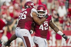 Defensive ends Trey Flowers (left) and Chris Smith celebrate after a sack.