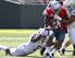 Tony Washington (ground) helps on a tackle