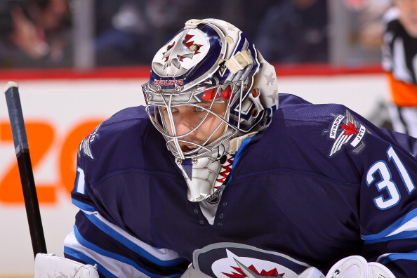 Winnipeg Jets goaltender Ondrej Pavelec (31) is hit in the mask by