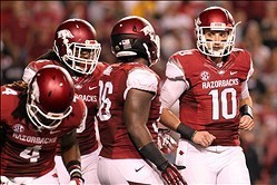 Quarterback Brandon Allen (right) talks with teammates before taking the field against Texas A&M.