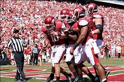 QB Brandon Allen is mobbed by teammates after running for a score.