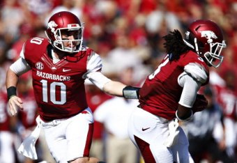 (Left) QB Brandon Allen hands off to RB Alex Collins.