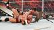 CM Punk crashes through the table onto Ryback.