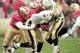 A man with a name above all others—Cedric Killings (No. 71) sacks New Orleans Saints quarterback Aaron Brooks.