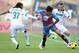 Ezequiel Schelotto and Jasmin Kurtic of Sassuolo battle Catania's Lucas Castro.
