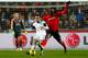 Leon Britton under pressure from Cardiff City's Kenwyne Jones.