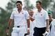 Australians Jason Day and Adam Scott walk off the 18th green Sunday.