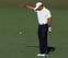 Tiger Woods drops after his previous shot hit the flagstick and bounced into the water on the 15th hole in the second round at the 2013 Masters.