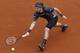 Lukas Lacko reaches for the ball in his opening-round match against Roger Federer at the 2014 French Open.