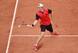 Jan-Lennard Struff slides to the ball during a match at the 2014 French Open.