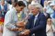 Bjorn Borg, who won six French Open titles, hands the winner's trophy to Rafael Nadal, who won his ninth.