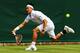 Kei Nishikori dashes to make a play on the ball during a match at 2014 Wimbledon.