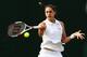 Andrea Petkovic hits a forehand during a match at 2014 Wimbledon.