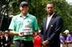 Bill Haas received the 2013 National trophy from host Tiger Woods.