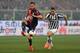 Stefano Sturaro controls the ball as Dani Osvaldo approaches to challenge.
