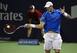 John Isner hits a forehand during a match at the Rogers Cup.
