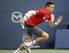 Milos Raonic chases the ball in a match against Jack Sock at 2014 Rogers Cup in Toronto.
