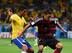 Paulinho squares up against Germany's Arsenal attacker Mesut Ozil during Brazil's embarrassing World Cup defeat to the eventual winners.