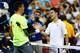 Milos Raonic and Kei Nishikori shake hands after U.S. Open match.