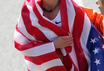 Kara Goucher wrapped with an American flag after making her 2008 debut in New York