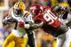 LSU running back Leonard Fournette (left) attempts to burst through the tackle of Alabama Jarran Reed.