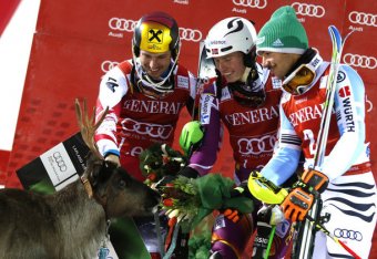 Henrik Kristoffersen (centre) meets his new reindeer Lars after winning the Levi slalom race.