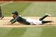 Burns slides into third base in a game against the Los Angeles Angels.