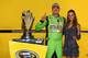 Kyle Busch with wife Samantha and the Sprint Cup championship trophy at Homestead.