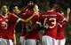 Rooney is congratulated on his goal against Derby.