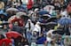 Fans cover up to endure rainy weather at Roland Garros at the 2016 French Open.