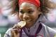 Serena Williams bites down on her gold medal after winning singles at the 2012 Summer Olympics in London.