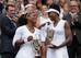 Serena and Venus Williams during the trophy ceremony after winning the doubles title at Wimbledon 2016.