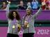 Serena and Venus Williams celebrate winning gold in women's doubles at the 2012 Olympics.