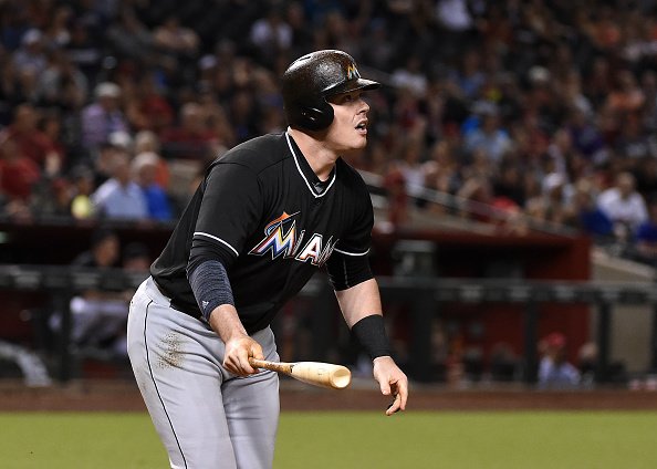 A Miami Marlins fan wears a bag over his head as Miami Marlins' Justin Bour  strikes out against the Milwaukee Brewers to end the eighth inning of a  baseball game Friday, April