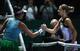 Garbine Muguruza, left, shakes hands with Karolina Pliskova after their match at the 2016 WTA Tour Finals in Singapore.